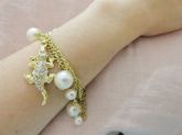 Pulseira dourada com perolas e ping. jacaré (strass)